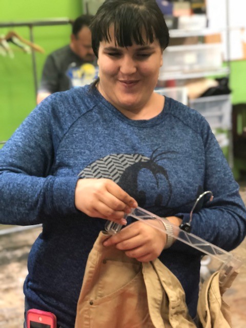 A student  working on hanging clothes as part of her vocational/work experience!