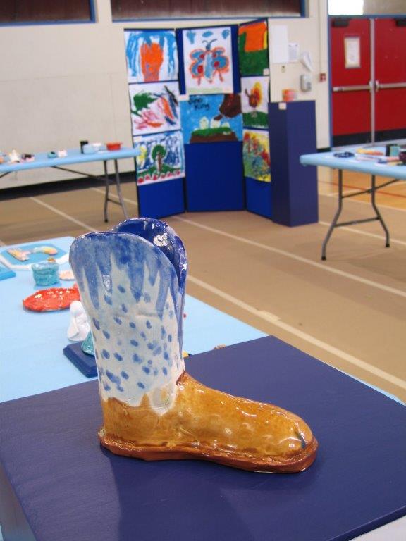 Ceramic of a two tone boot with blue and white top, and brown foot.