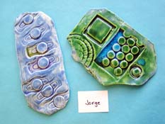 Light blue ceramic art piece, and green and blue ceramic art piece.