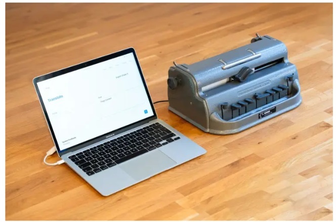 Paige Board Connected Brailler plugged in to a laptop