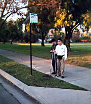 Two students waiting at a bus stop.