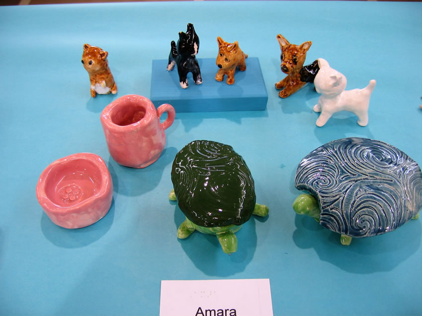 Small animal figures- turtles, cats, and dogs, with pinch pot and cup ceramics.