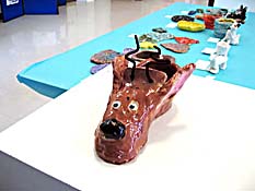 Hallow, brown ceramic dog head sculpture.